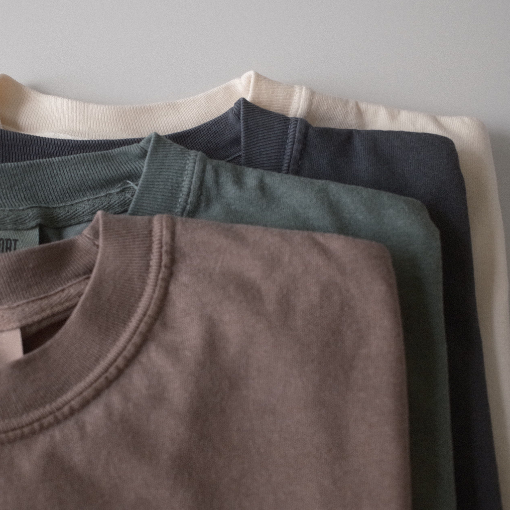 Folded t-shirts showing the four colors