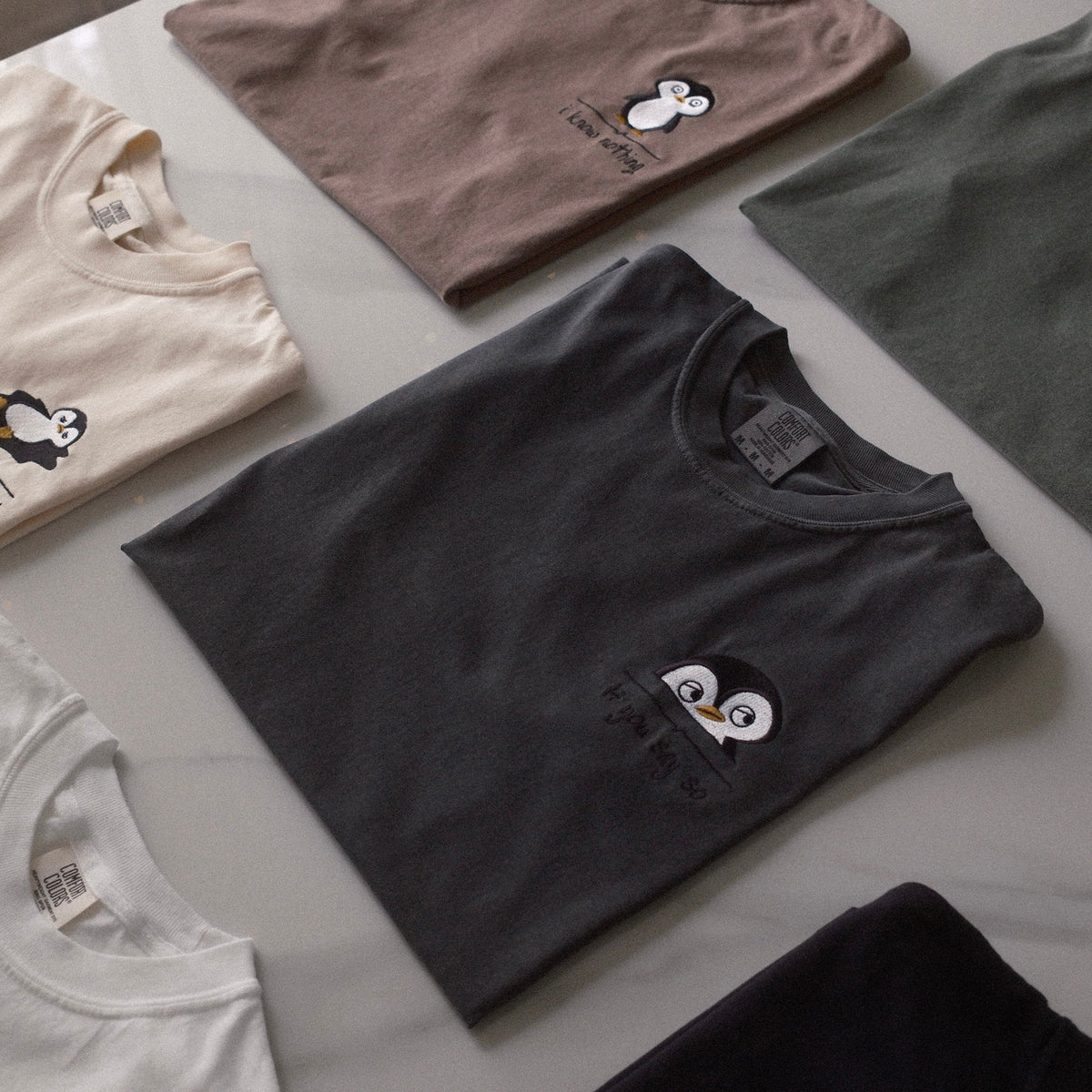 Desk Face t-shirts folded flat lay